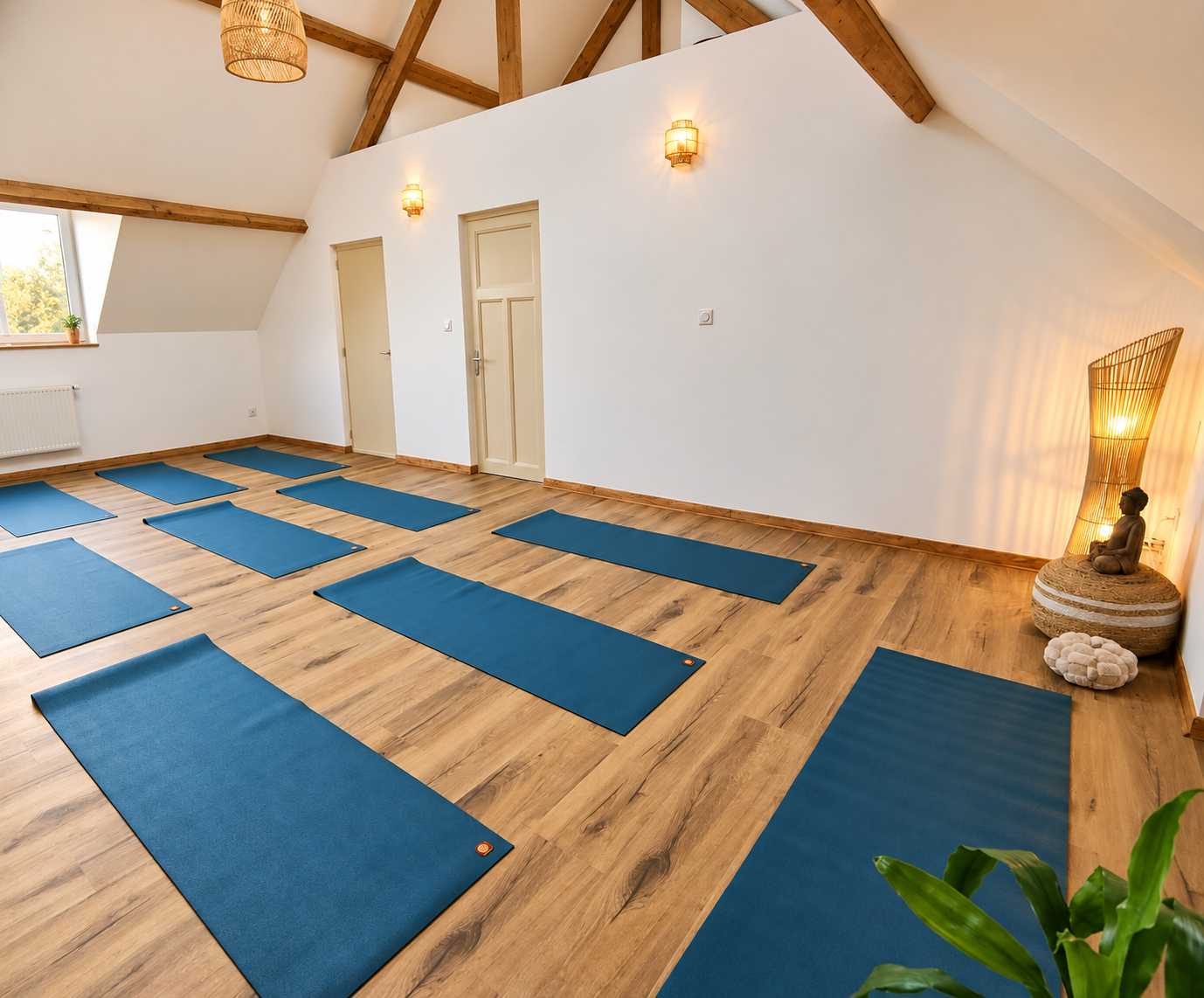 Vue de la salle de yoga avec ses poutres apparentes et son espace de pratique